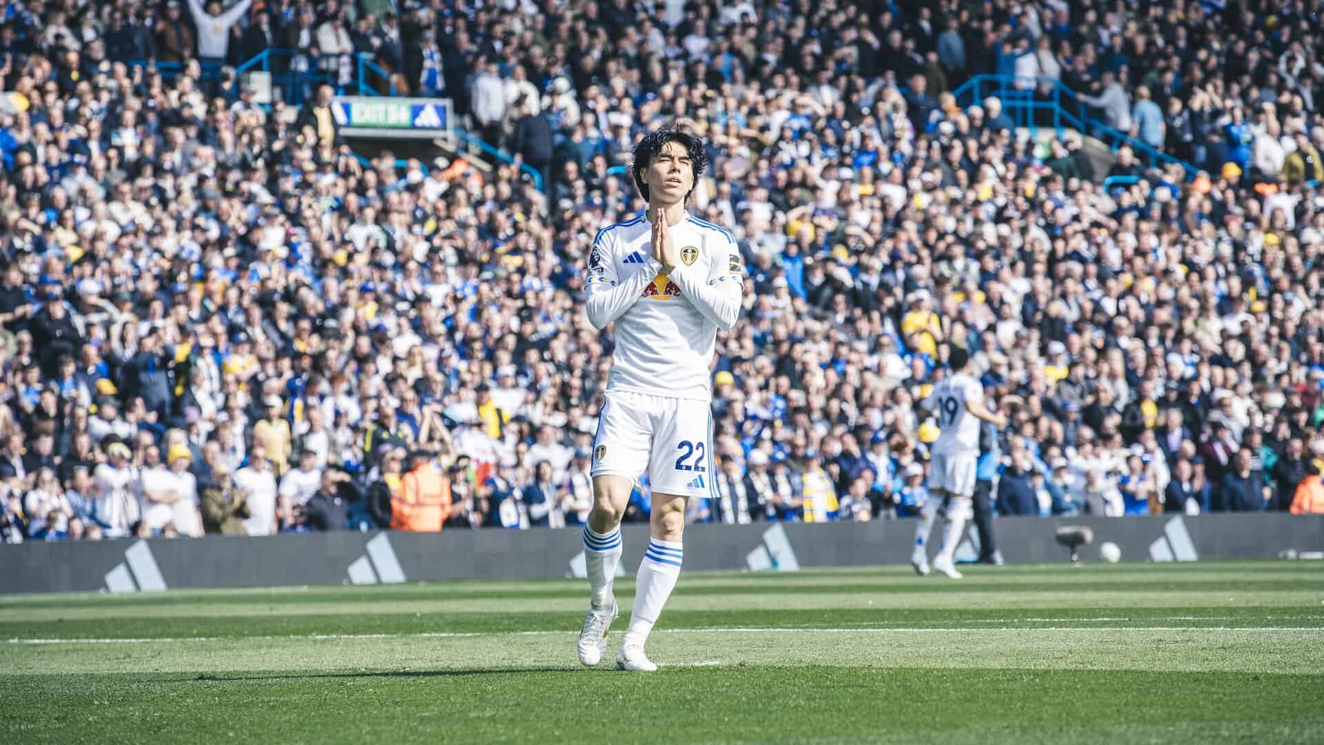Ao Tanaka, moments before kick off, clasping his hands together and shutting his eyes as he basks in the sunshine of Elland Road