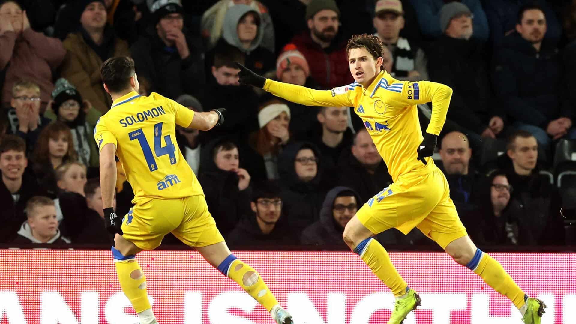 Brenden Aaronson runs away, arm aloft, celebrating his winning goal at Derby with Manor Solomon pointing at him. The Derby fans behind the goal look miserable. It's great.