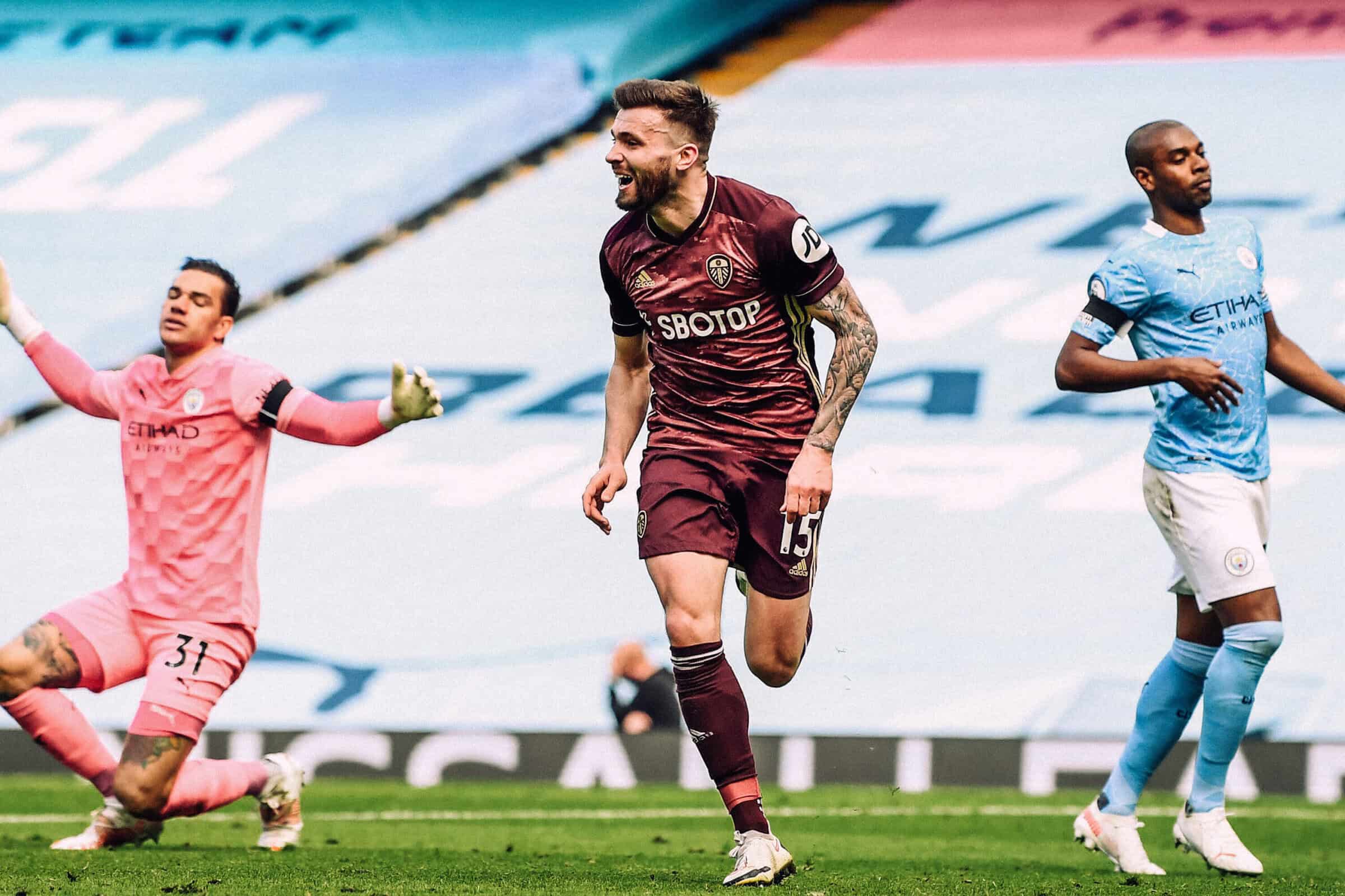 Stuart Dallas wheeling away in celebration after scoring his late winner at the Etihad with Ederson in the background waving his arms in the air, wondering what the hell has just happened
