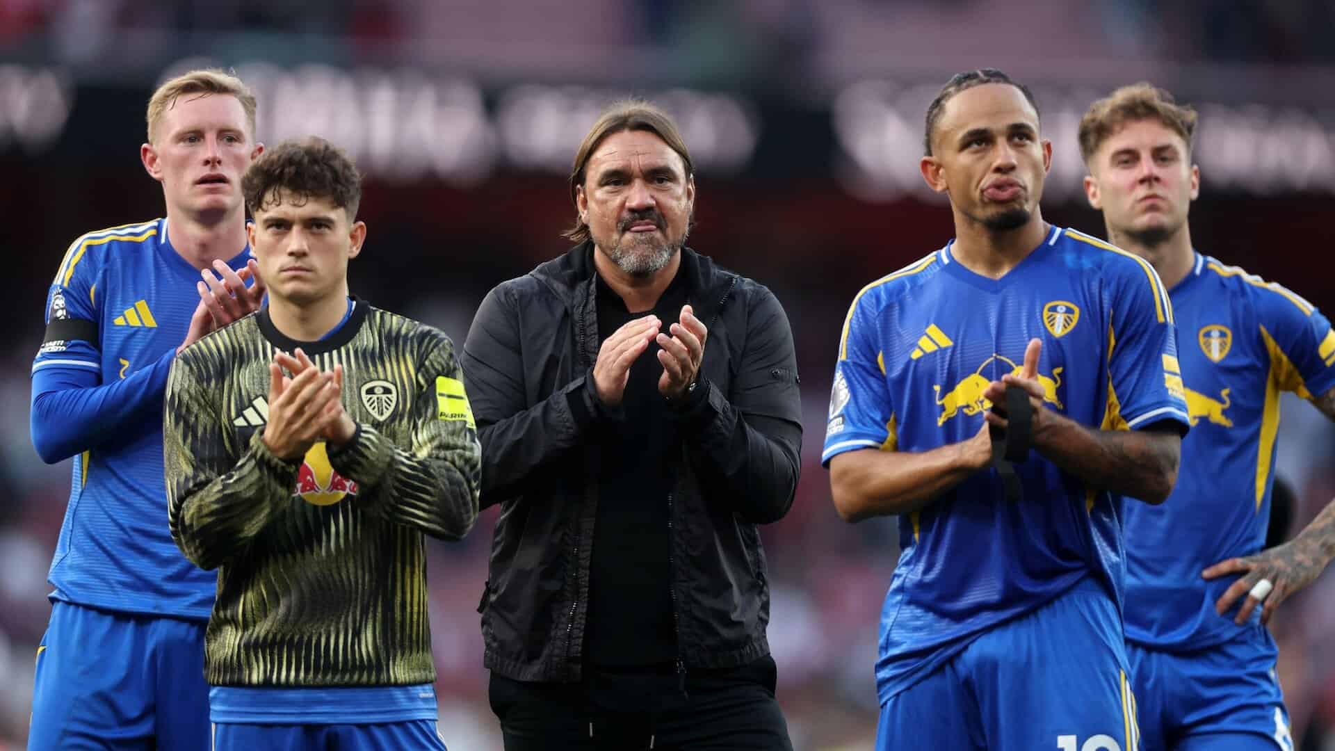Daniel Farke, Dan James, Noah Okafor, Joe Rodon and Sean Longstaff looking glum in front of the away end after Leeds' 5-0 defeat to Arsenal