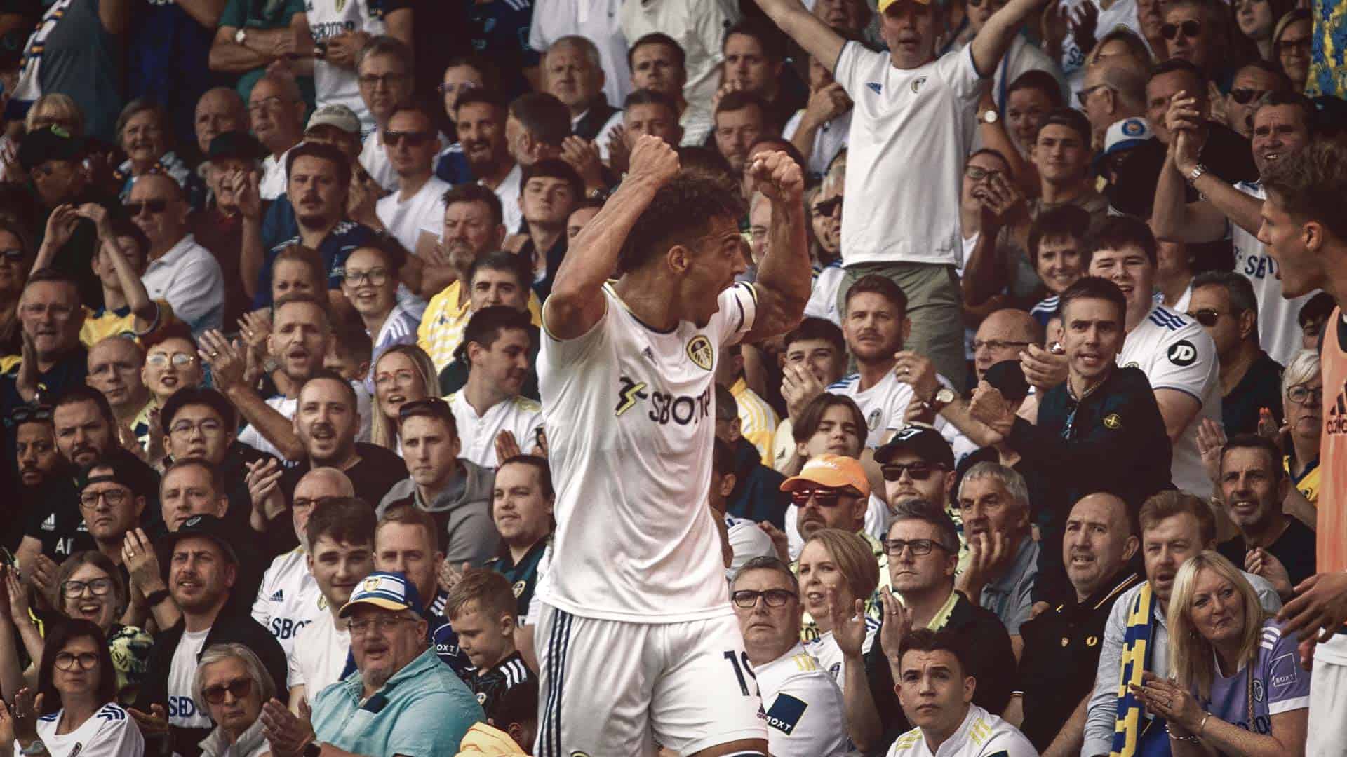 A photo of Rodrigo pumping his fists to the fans in the North-West corner at Elland Road against Chelsea