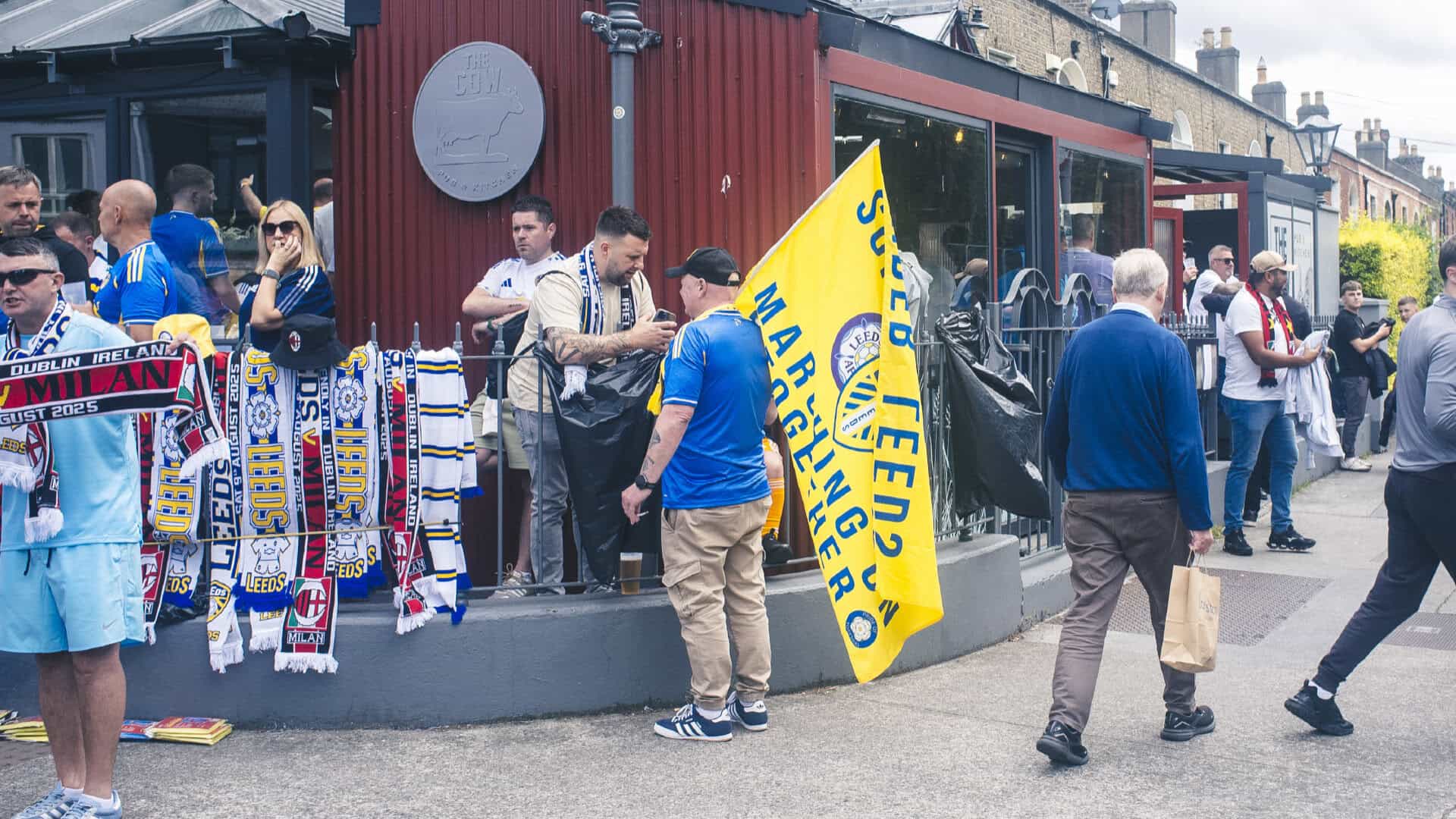 Leeds fans with flags and scarves filling a pub in Dublin