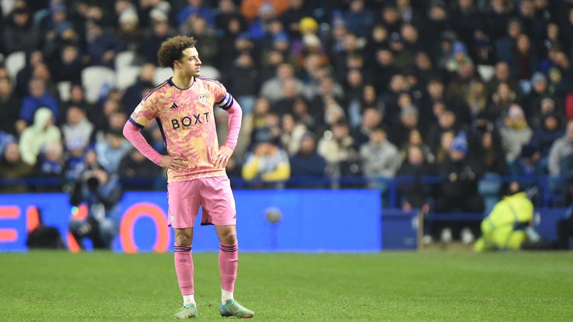 A photo of Ethan Ampadu at Hillsborough in the pink kit, his hands on his hips, looking off to his left