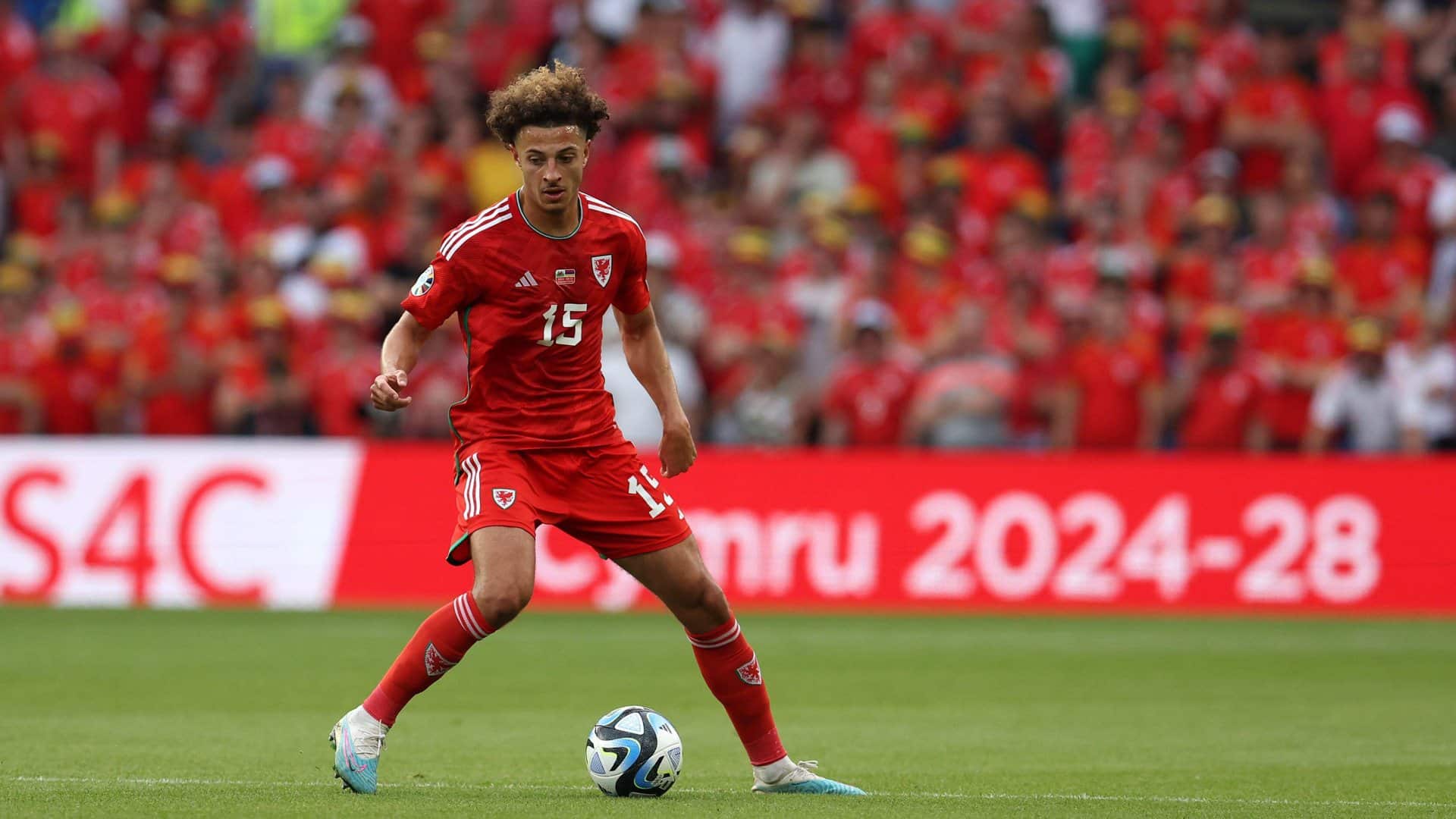 Ethan Ampadu in a red kit (it's Wales, forgive him) looking poised in possession like what we hope he'll be for Leeds