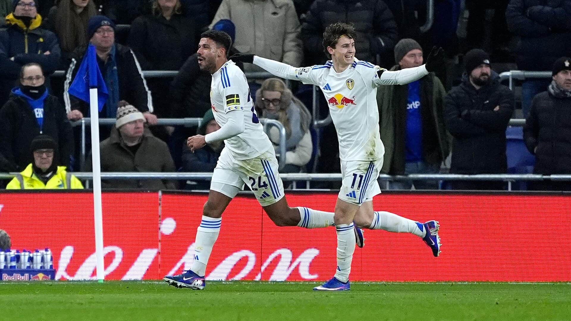 James Justin and Brenden Aaronson celebrating Leeds' opener at Everton in front of some very glum home fans
