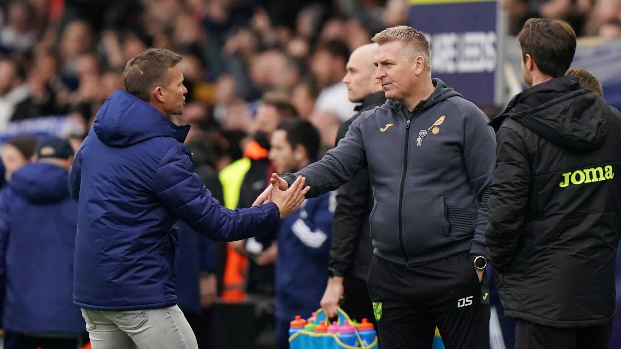 Jesse Marsch shaking hands with Dean Smith, who is standing there as if he's been waiting for ten years at the end of the game, not ten seconds