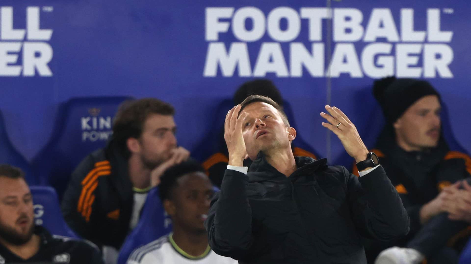 Jesse Marsch at Leicester, throwing his hands up in the air, with a big FOOTBALL MANAGER advert looming meaningfully behind him