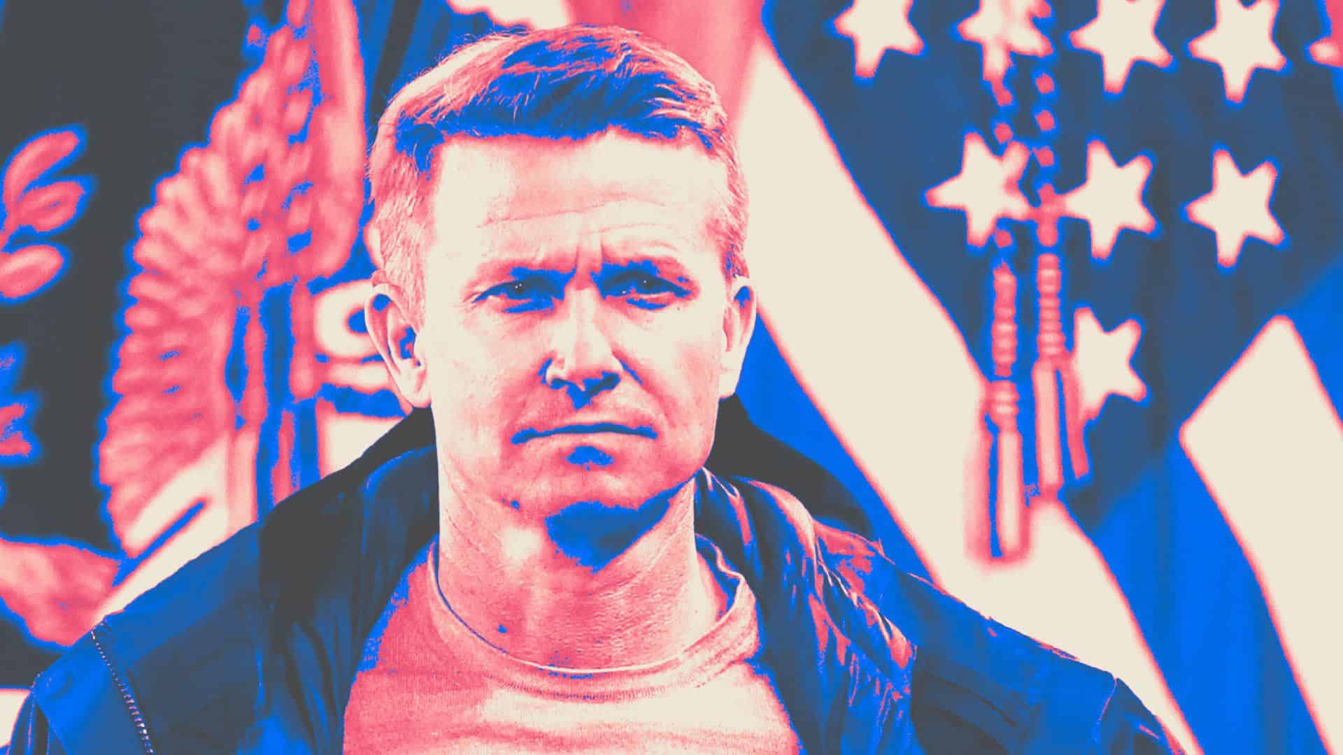 Jesse Marsch standing in front of a microphone, like always, against the backdrop of a USA flag, not like always