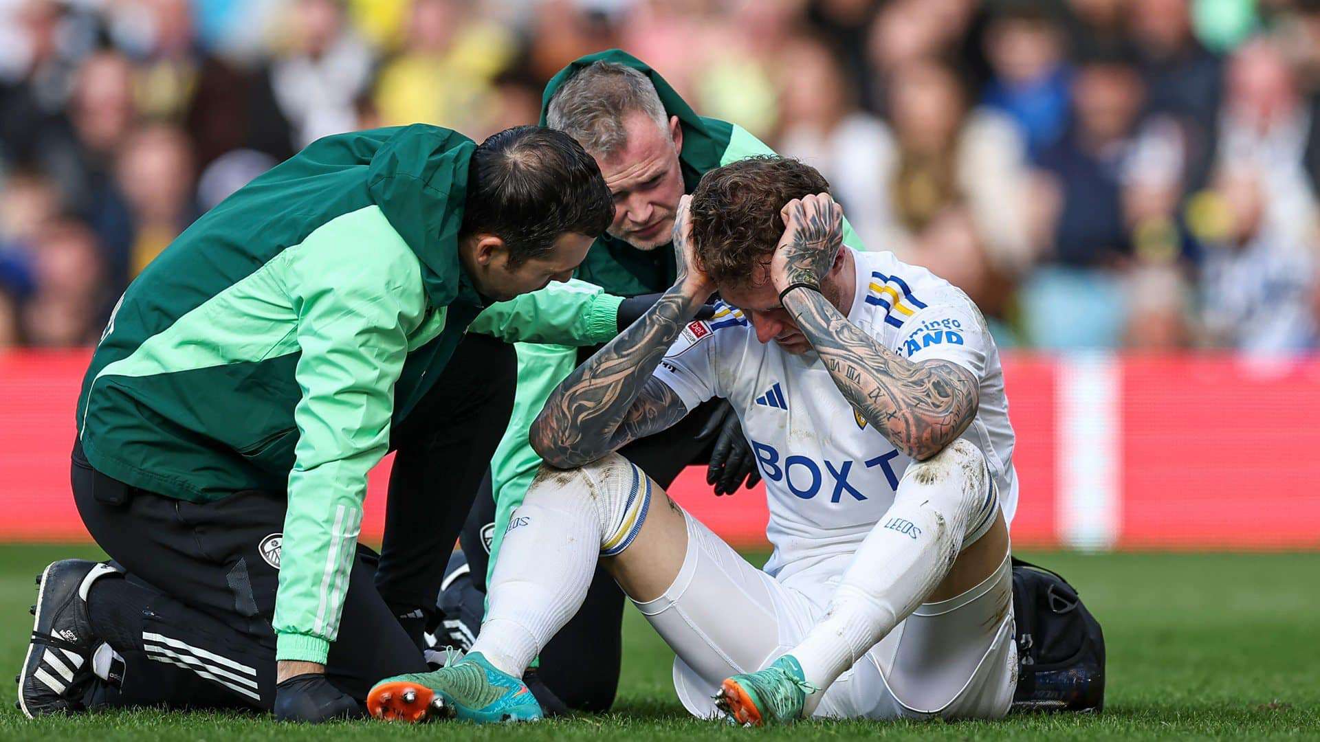 Joe Rodon sits on the ground getting treated after Millwall's Jake Cooper booted him in the head