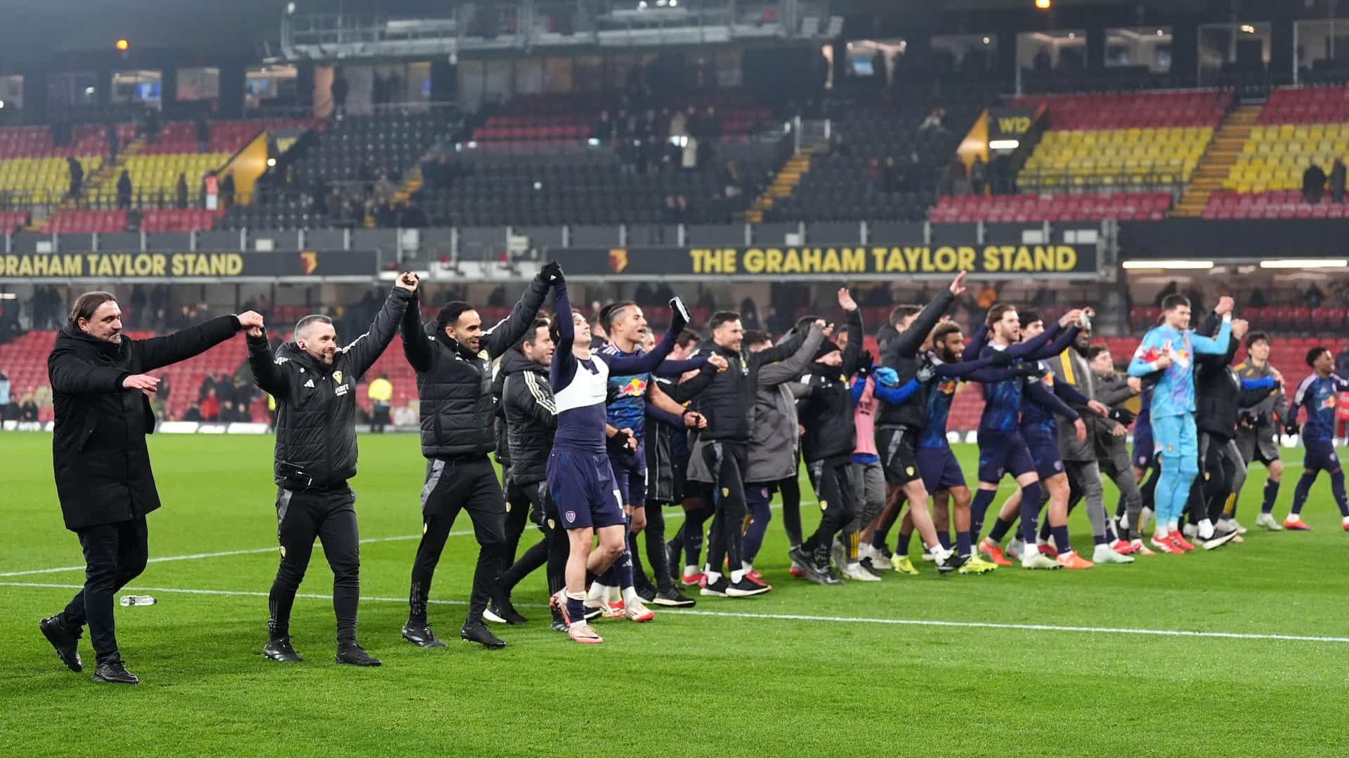 The entire Leeds team and coaching staff standing in a line saluting the magnificent away end after Leeds' win over Watford