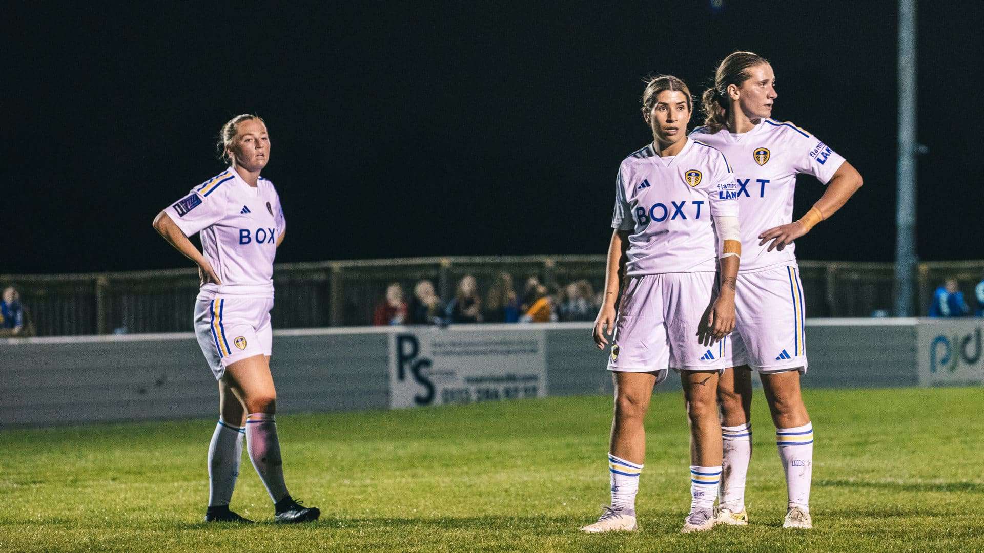 Ellie Dobson, Kathryn Smith and Katie Astle standing in a row during Leeds United Women's recent floodlit win over FCUM