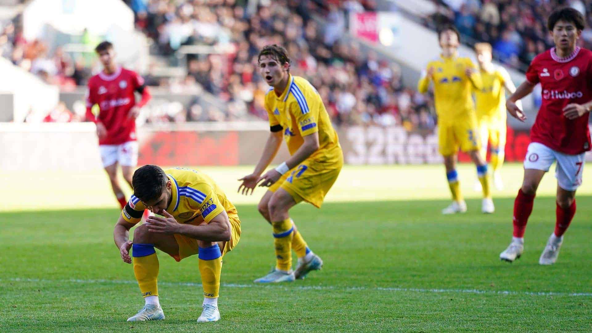 Manor Solomon holds his head in his hands at Bristol City with Brenden Aaronson in the background looking surprised at how bad they both are