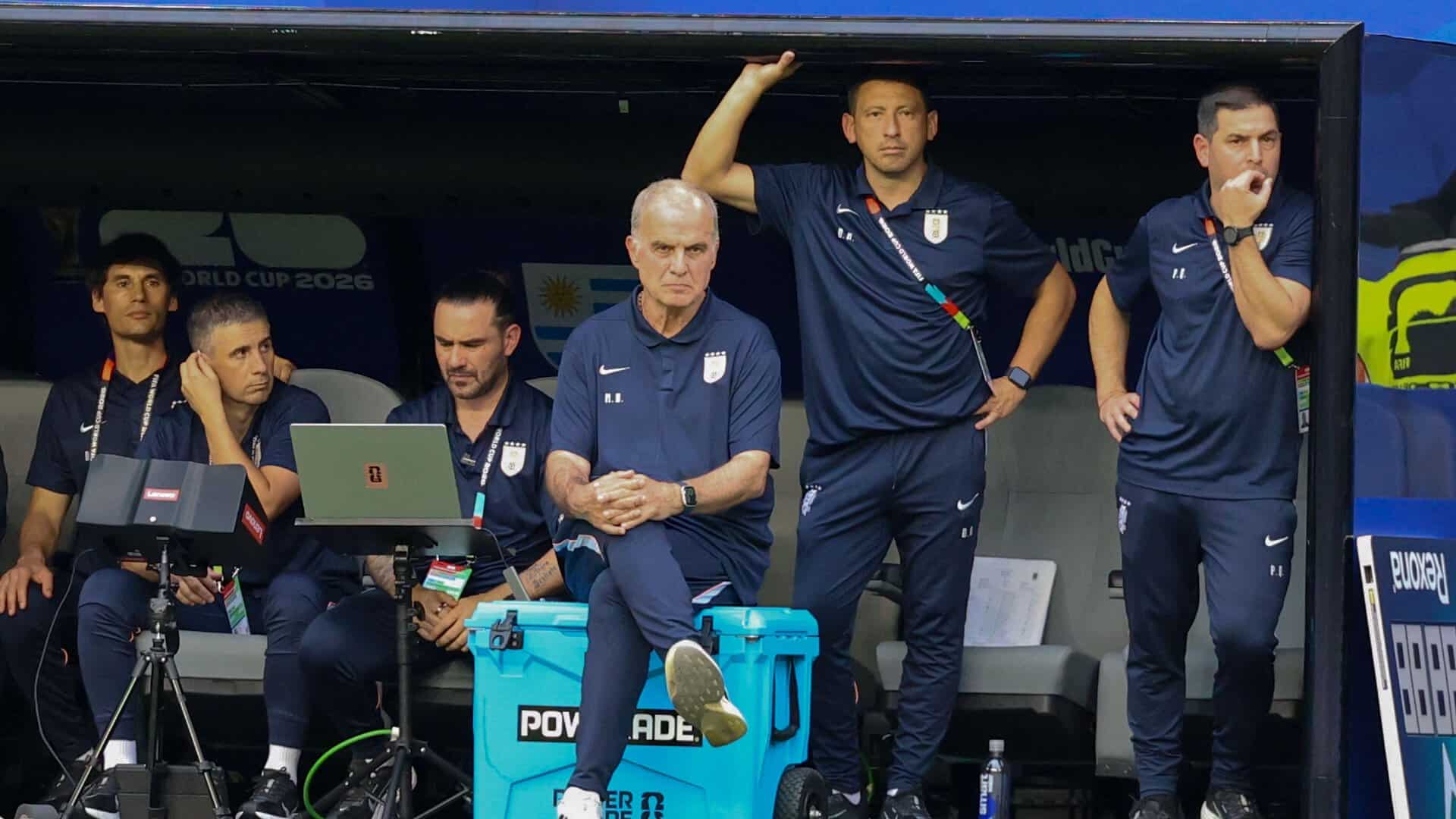 Marcelo Bielsa sitting cross legged on a water cooler with a brooding intensity during Uruguay's draw with Saudi Arabia