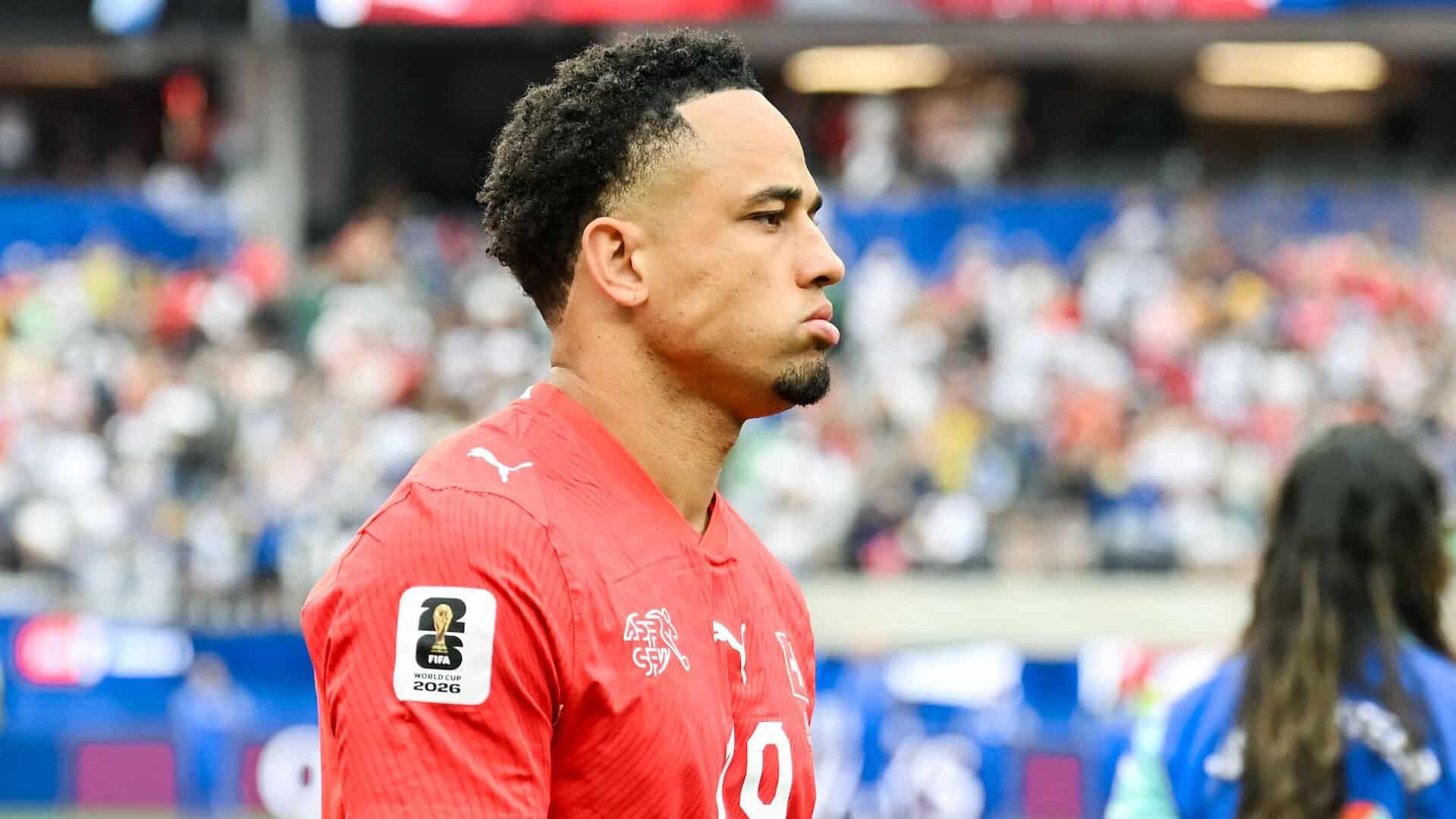 Noah Okafor in his unused Switzerland kit at the end of a game. He looks absolutely delighted (by I mean he looks absolutely miserable)