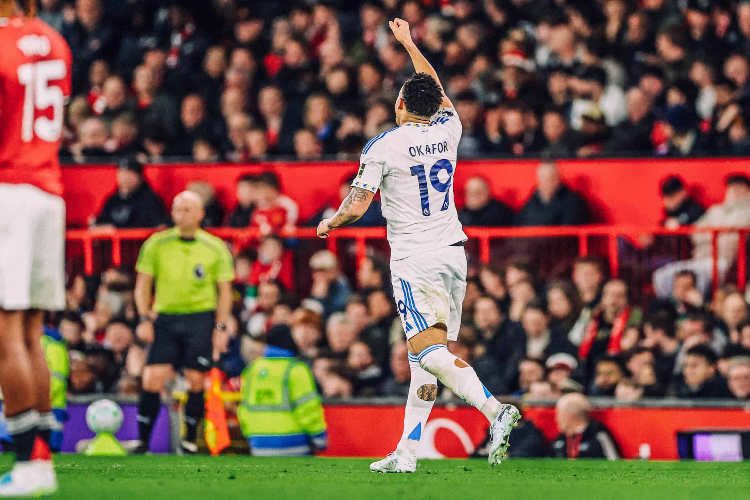 Noah Okafor, arm aloft, after scoring at Old Trafford. Just out of shot is Bruno Fernandes spitting his dummy out and pretending not to cry in front of the referee