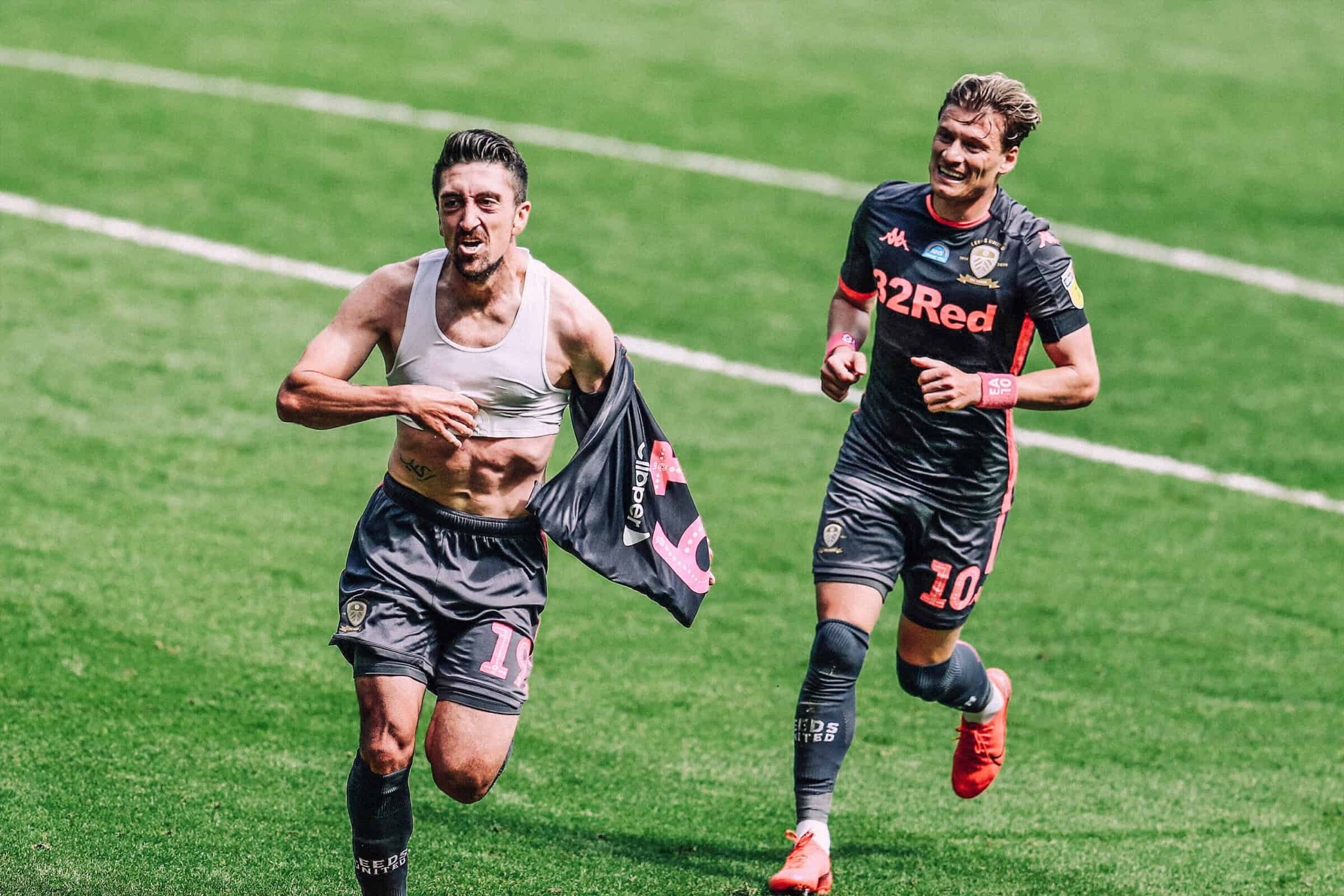 Pablo Hernandez celebrating THAT goal at Swansea, shirt off, showing off his little sports bra, with Gjanni Alioski chasing after him