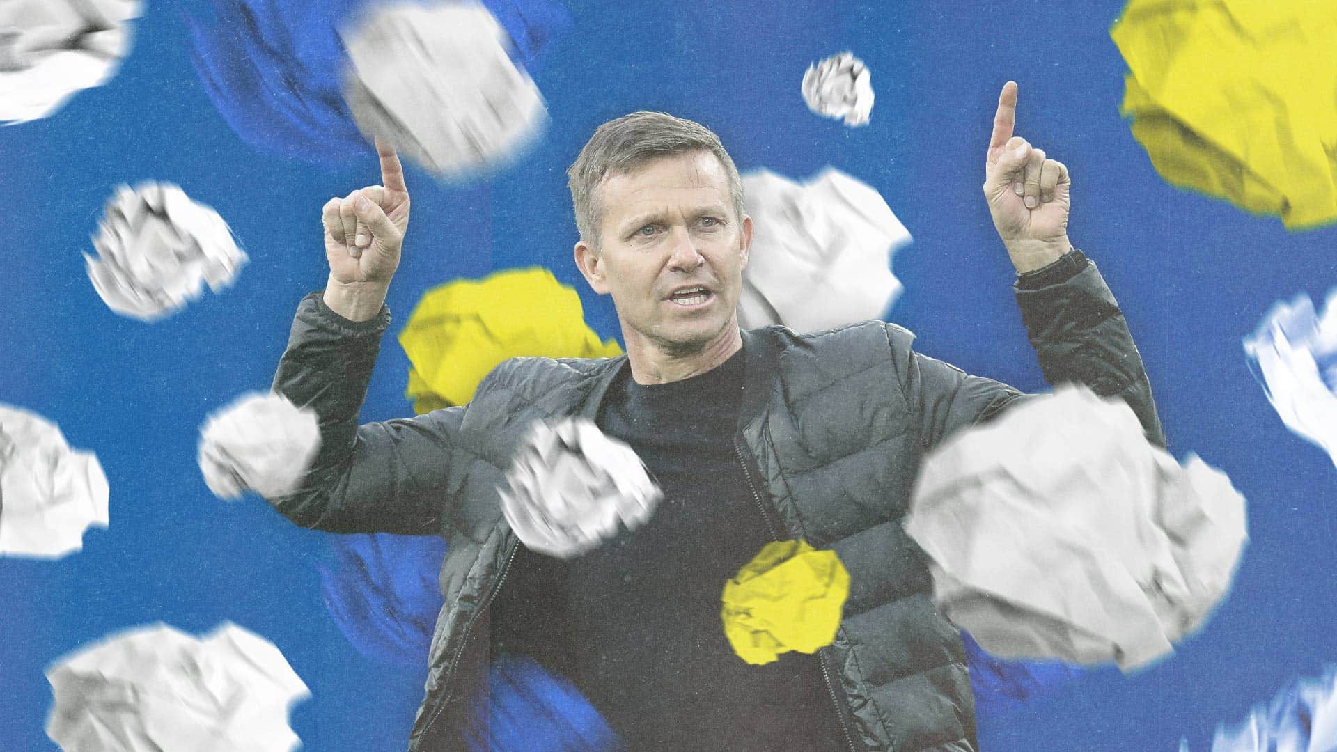 Jesse Marsch, pointing to the sky like a dad dancing at a wedding, surrounded by scrunched up balls of paper