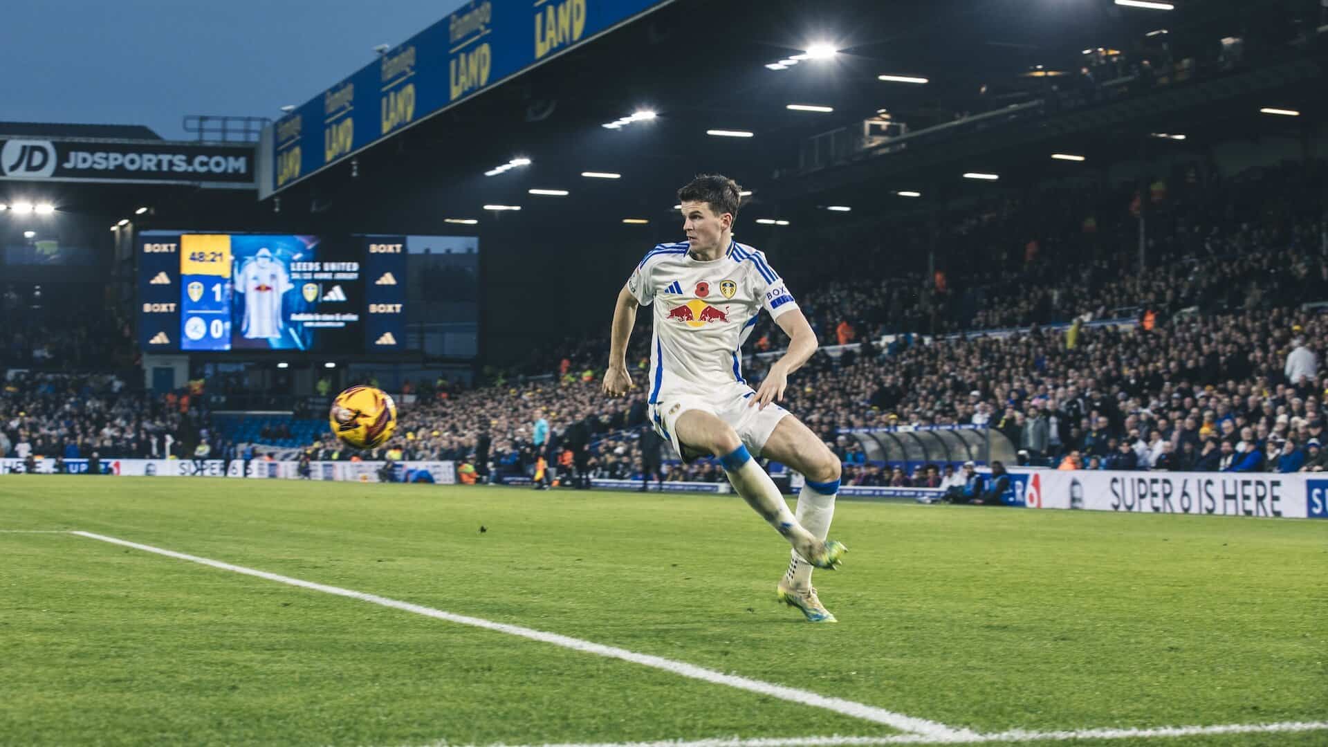 Sam Byram controlling a football on the left wing during a game at Elland Road. He looks resplendent