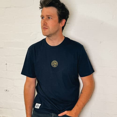 Poet Matt Abbott wearing our navy t-shirt with a TSB logo embroidered in yellow to the centre of the chest