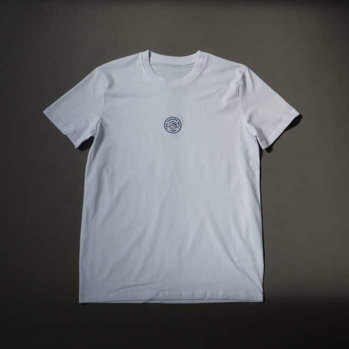 A flat photo of our white t-shirt with a TSB logo embroidered in navy to the centre of the chest