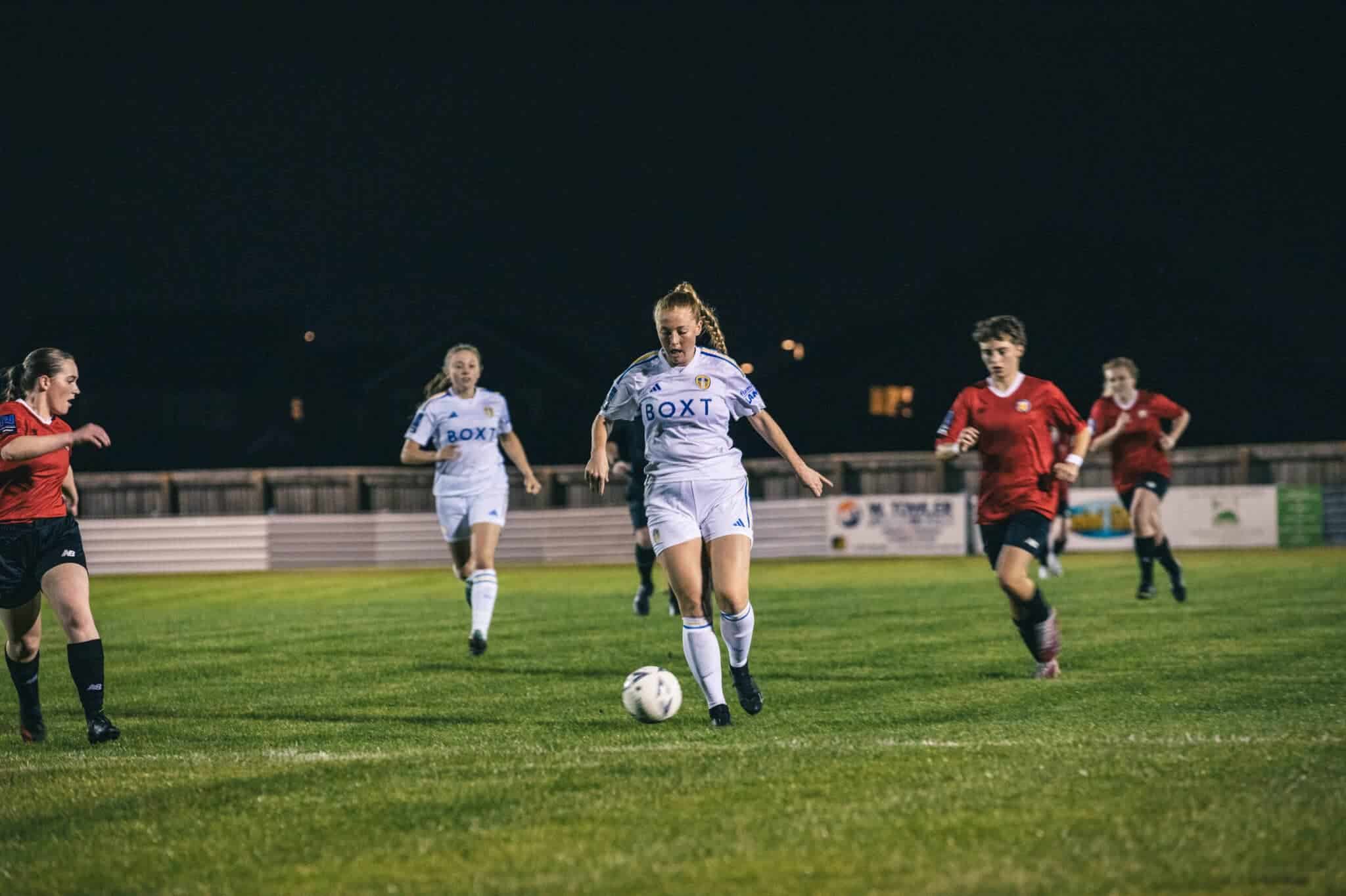 Leeds United Women's player Ellie Dobson dribbling with the ball at her feet