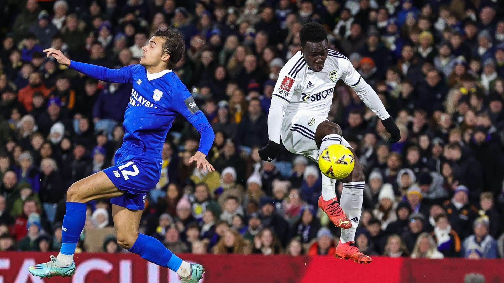 Wilf Gnonto against Cardiff. What a goal. This photo captures him mid-air, just connecting with the ball, while the defender flails in the sky with his eyes shut. Beautiful